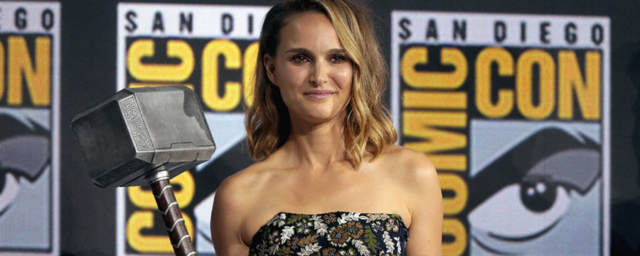 Natalie Portman Smiling and Holding Tor's Hammer at the San Diego Comicon event.