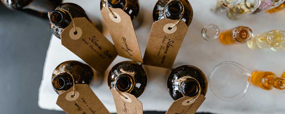 Brown Bottles with Tags on a White Surface