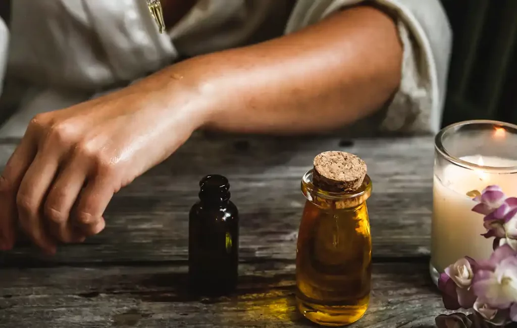 Different oils and a candle on a table